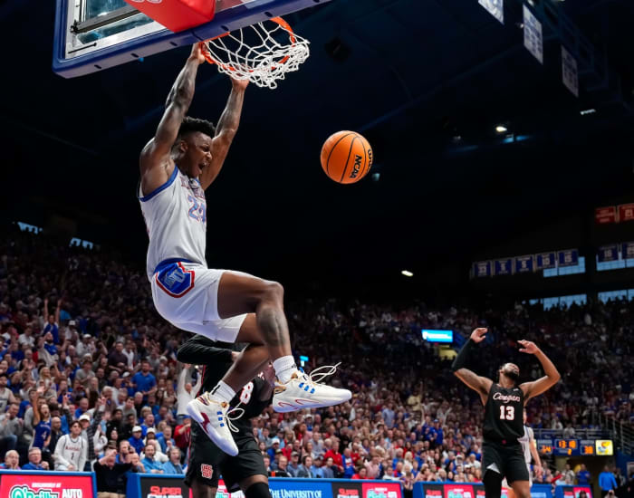 Kansas Jayhawks forward K.J. Adams Jr. (24) dunks the ball against Houston Cougars guard Mylik Wilson (8) during the second half at Allen Fieldhouse in Lawrence, Kansas, on. Feb. 3, 2024.